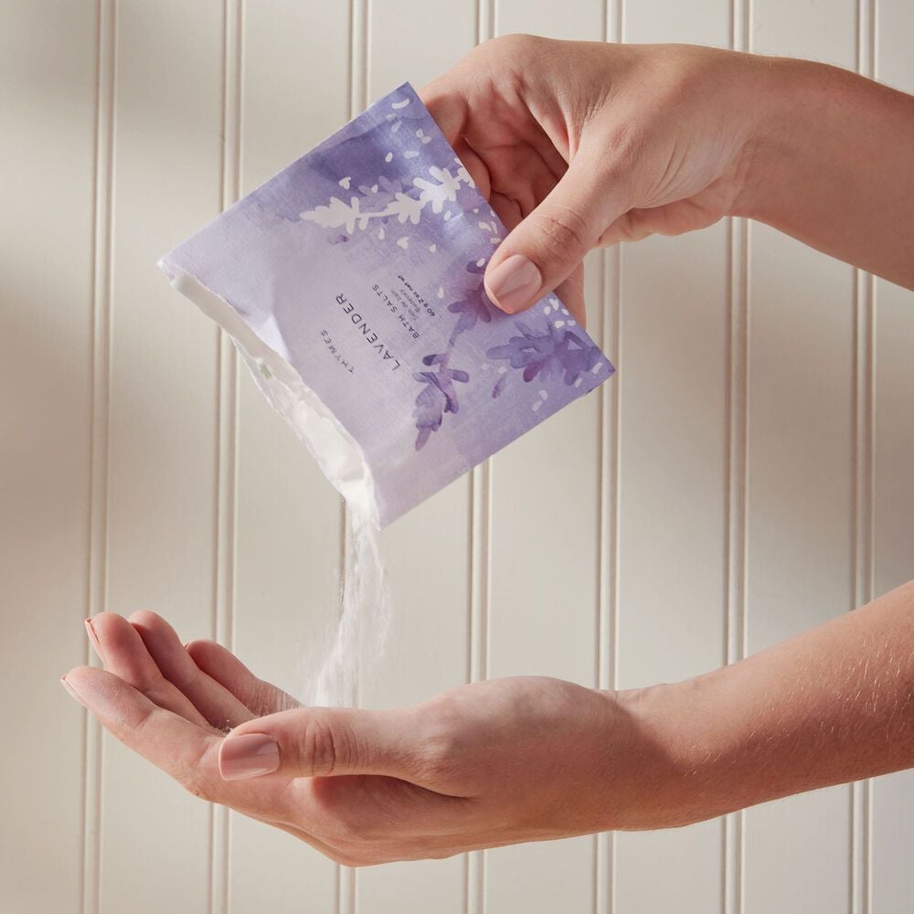 Thymes Lavender Bath Salts with Art Packaging being poured into hand image number 1